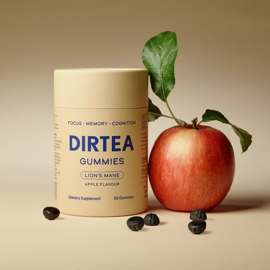 DIRTEA Lion's Mane Gummies jar beside an apple and dark gummies.