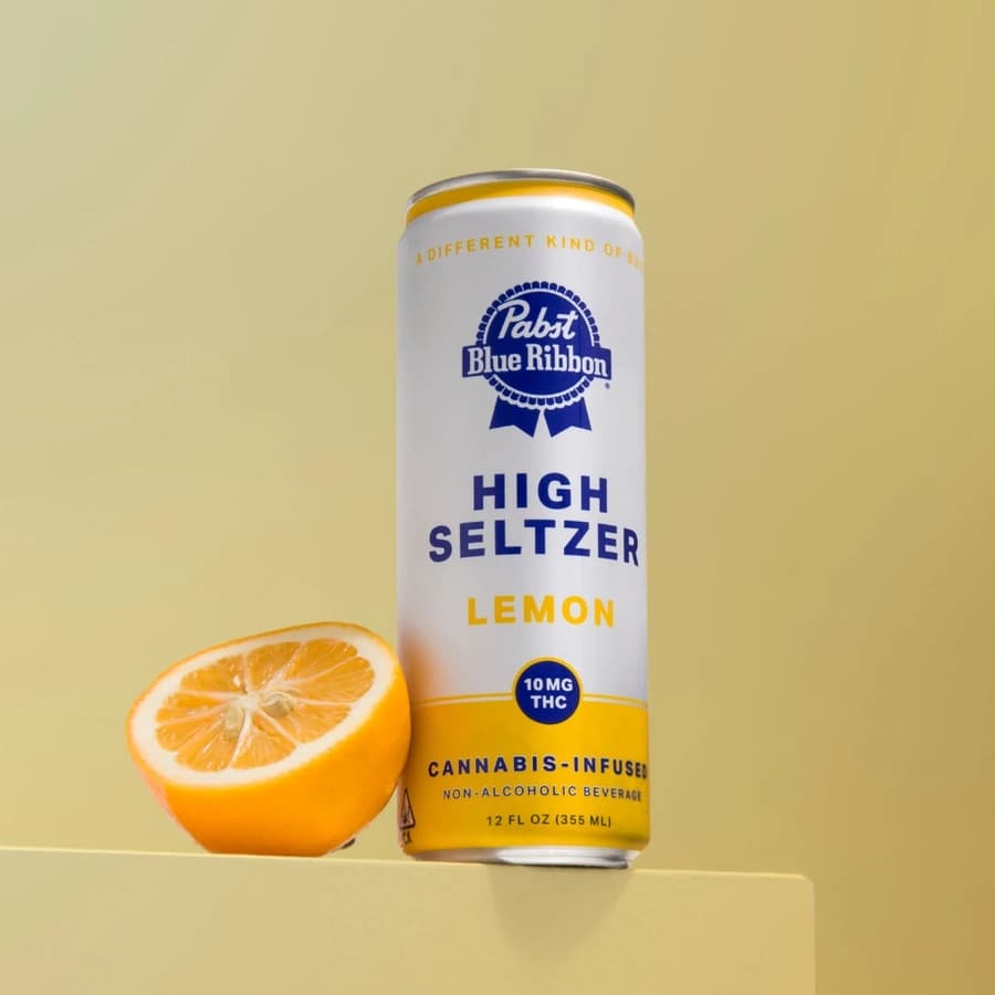 Pabst Blue Ribbon High Seltzer Lemon can on a yellow surface.